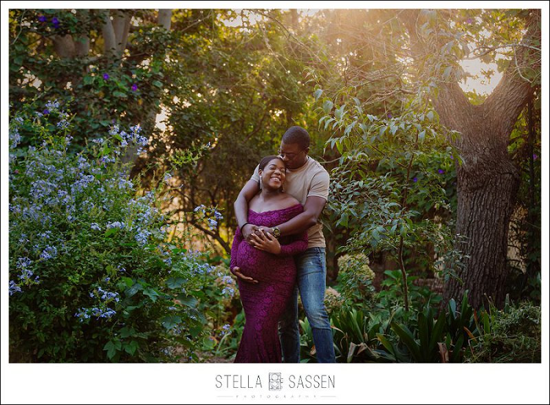 Outdoor maternity shoot under trees with soft light