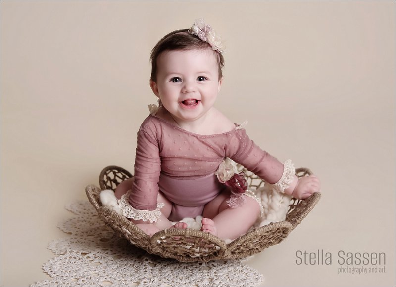 sitter shoot toddler in prop for photo shoot