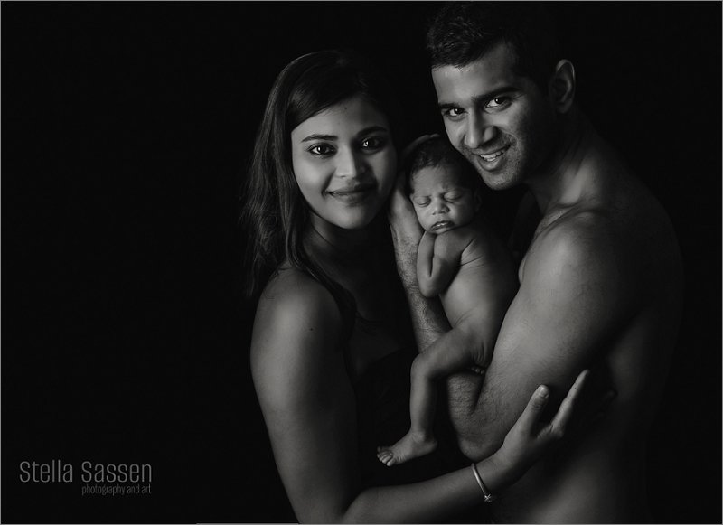 black and white photograph couple with newborn baby in studio