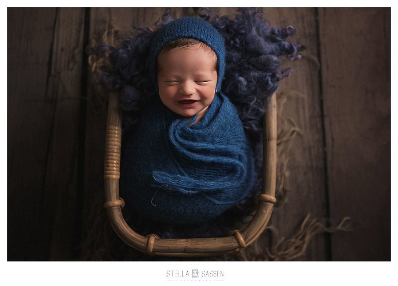 Newborn baby smiling during photo shoot