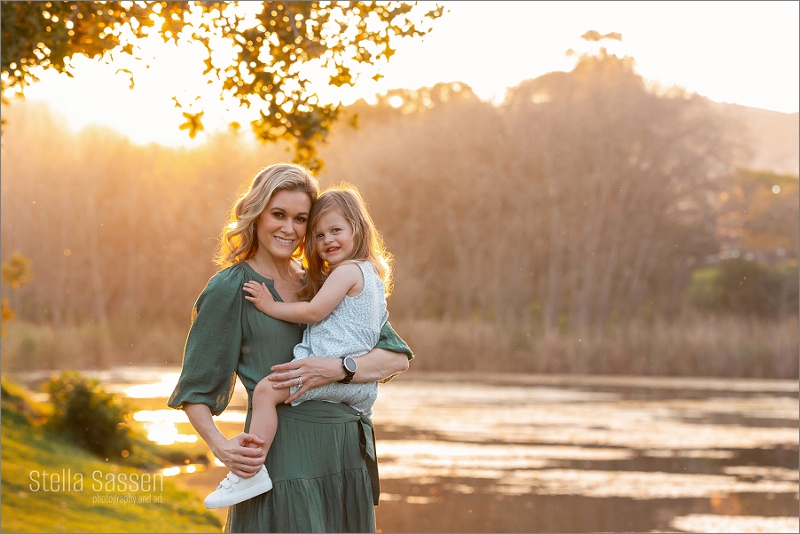 Mommy and me photo shoot against a beautiful sunset over a lake